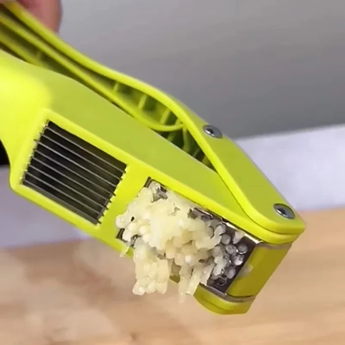 Close-up of a 2-in-1 garlic press and slicer with minced garlic ready for cooking.