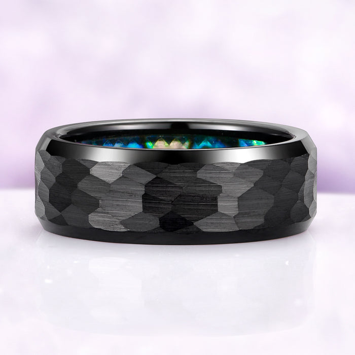 Black tungsten ring with geometric pattern on a white background