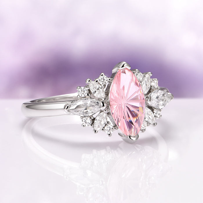 Adeline Unique Fireworks Cut Morganite Couples Ring Set by Aquamarise featuring a marquise-cut pink morganite centerpiece surrounded by sparkling white cubic zirconia accents on a polished sterling silver band, elegant and modern.