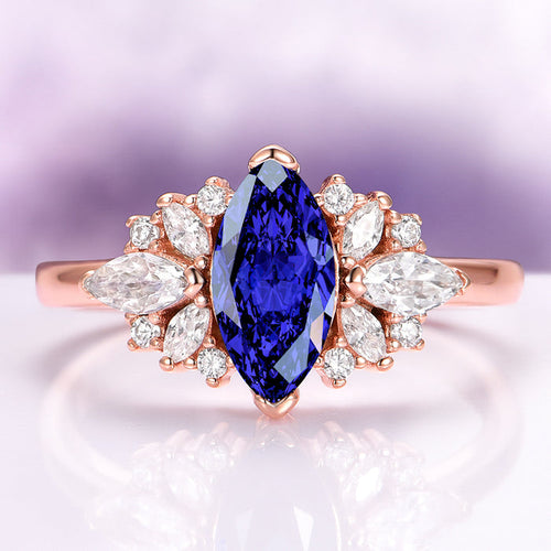 Adeline Marquise Cut Flower Blue Sapphire Engagement Ring in 14K Solid Rose Gold by Aquamarise Gold, featuring marquise blue sapphire with floral diamond accents on a rose gold band.