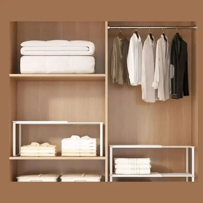 Organized closet featuring an adjustable closet shelf organizer and neatly hung clothes.
