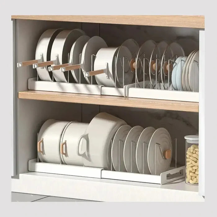 Adjustable pot and pan organizer in a kitchen cabinet keeping cookware upright and separated.