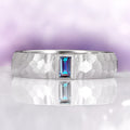 Alexandrite Hammered Wedding Band in 14K White Gold (5.5mm) by Aquamarise Gold featuring a unique hammered texture and a central emerald-cut alexandrite stone with a polished brushed finish, part of Men's and Women’s Wedding Bands collections.
