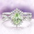 Alice Fireworks Cut Light Green Sapphire Engagement Ring Set in 14K White Gold by Aquamarise Gold featuring a pear-cut light green sapphire surrounded by a sparkling diamond halo on an intricately twisted white gold band, part of Solid Gold Engagement Rings and September Birthstone Jewelry collections.