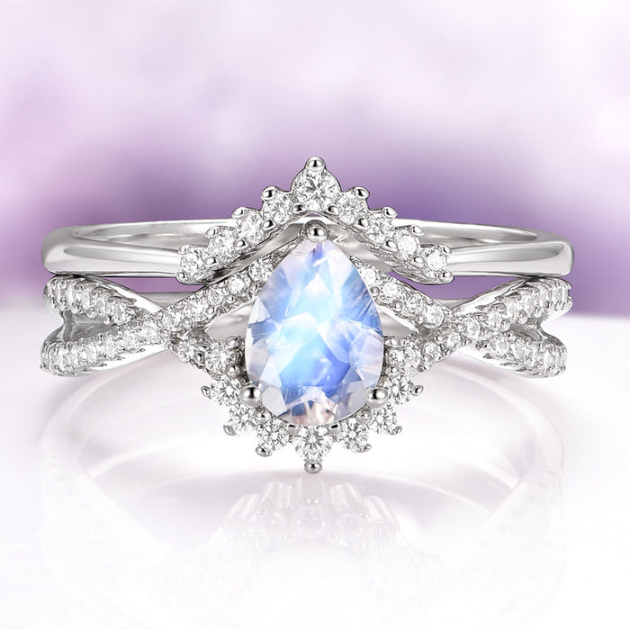 Alice Rainbow Moonstone Couples Ring Set by Aquamarise featuring a pear-shaped moonstone surrounded by delicate diamond accents in a unique, ethereal design for matching couples rings.