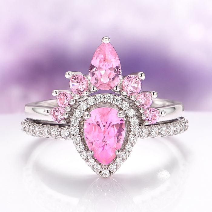 Amy Pink Sapphire Engagement Ring Set in Sterling Silver by Aquamarise featuring a pear-cut pink sapphire with smaller pink sapphires and diamond accents in a vintage-inspired design.