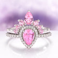 Amy Pink Sapphire Engagement Ring Set in Sterling Silver by Aquamarise featuring a pear-cut pink sapphire with smaller pink sapphires and diamond accents in a vintage-inspired design.