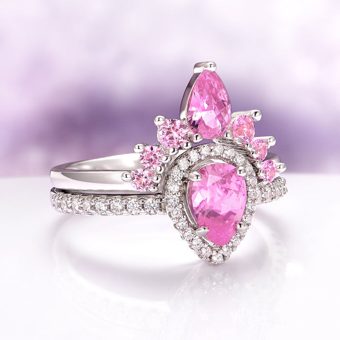Amy Pink Sapphire Engagement Ring Set in Sterling Silver by Aquamarise featuring a pear-cut pink sapphire with smaller pink sapphires and diamond accents in a vintage-inspired design.