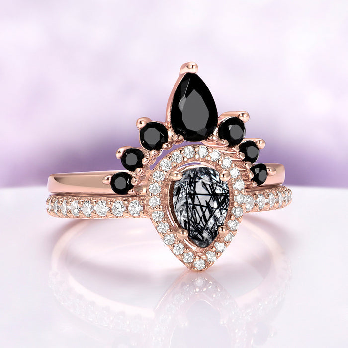 Amy Rutilated Quartz & Black Onyx Ring Set in 14K Rose Gold Vermeil by Aquamarise, featuring pear-shaped rutilated quartz surrounded by pavé diamonds and black onyx accents on rose gold bands.