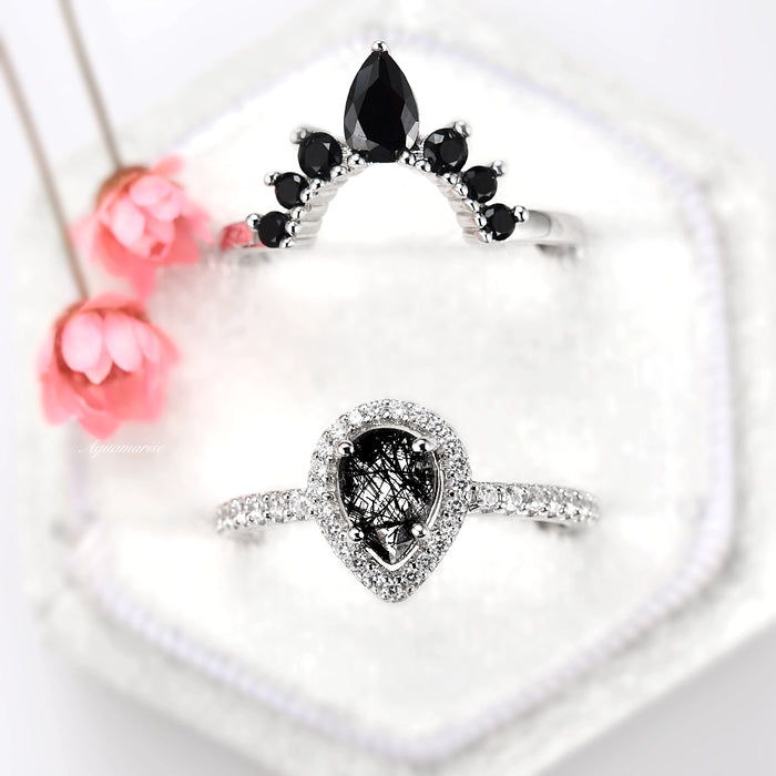 Amy Rutilated Quartz & Black Moissanite Engagement Ring Set in 14K White Gold by Aquamarise Gold, featuring a pear-shaped rutilated quartz with black moissanite accents on a pavé diamond band.