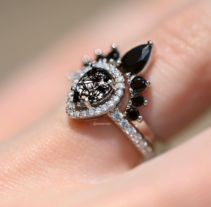 Amy Rutilated Quartz & Black Moissanite Engagement Ring Set in 14K White Gold by Aquamarise Gold, featuring a teardrop rutilated quartz center and black moissanite accents on a pavé diamond band.