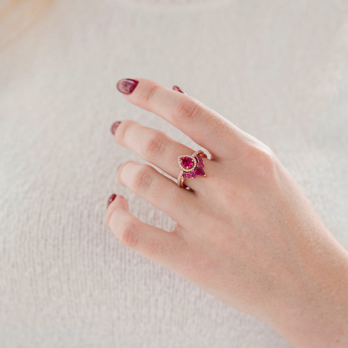 Amy Teardrop Lab-Grown Ruby Ring Set in 14K Rose Gold Vermeil by Aquamarise, featuring vibrant pear-shaped rubies with accent stones on a hand, from the Rose Gold Vermeil Rings collection.
