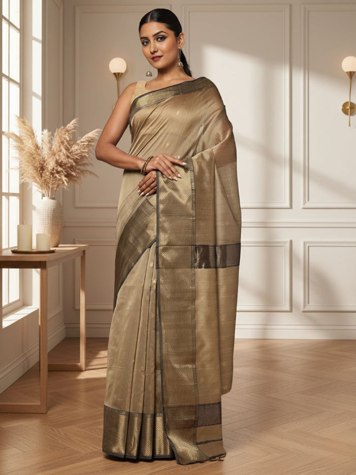 Antique gold Maheshwari silk saree with small buti and a wide charcoal grey pallu border with copper detailing, handwoven in Maheshwar