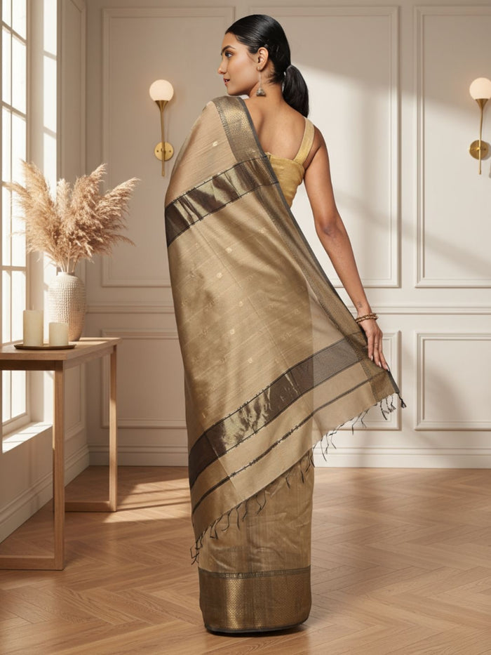 Antique gold Maheshwari silk saree with small buti and a wide charcoal grey pallu border with copper detailing, handwoven in Maheshwar