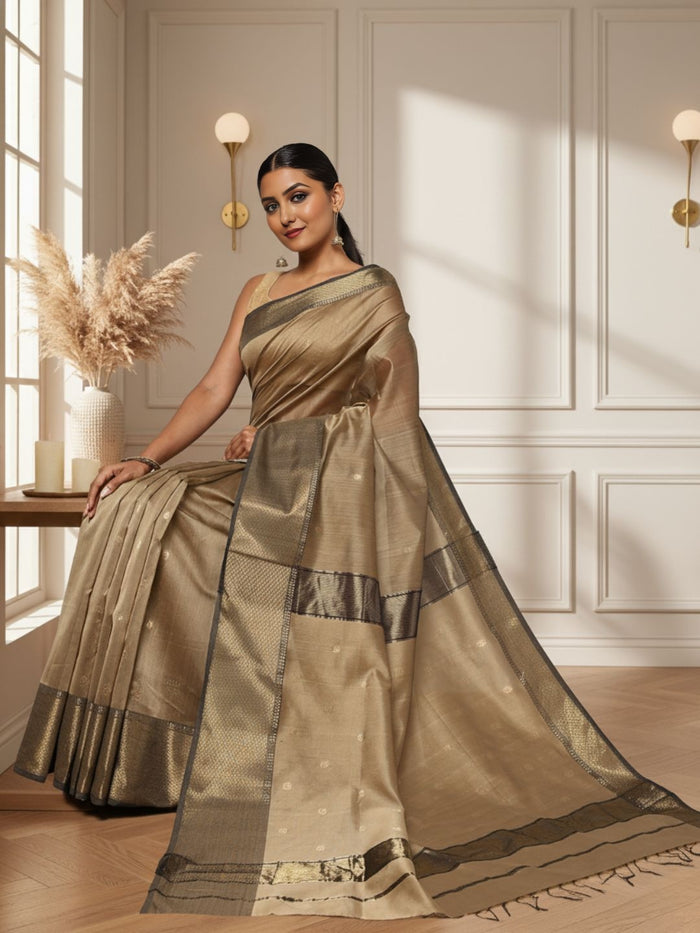 Antique gold Maheshwari silk saree with small buti and a wide charcoal grey pallu border with copper detailing, handwoven in Maheshwar