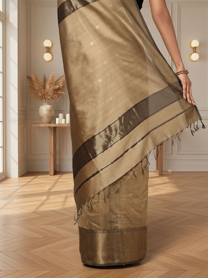 Antique gold Maheshwari silk saree with small buti and a wide charcoal grey pallu border with copper detailing, handwoven in Maheshwar