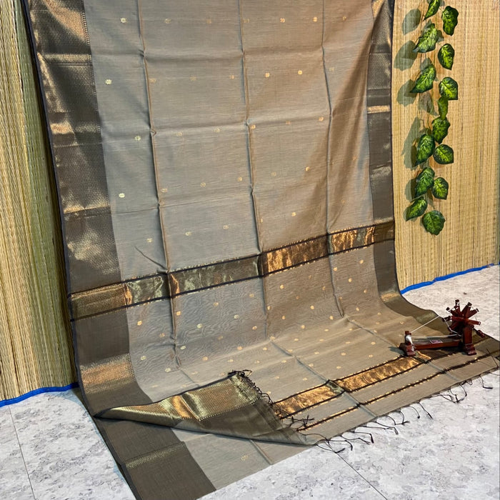 Antique gold Maheshwari silk saree with small buti and a wide charcoal grey pallu border with copper detailing, handwoven in Maheshwar