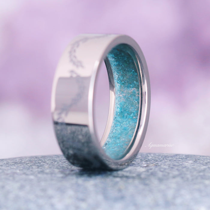 Crushed Aquamarine Leaf Wedding Band- 8MM Titanium featuring a polished titanium exterior with delicate leaf engravings and a vibrant crushed aquamarine inlay, showcasing Aquamarise’s nature-inspired men’s jewelry craftsmanship.