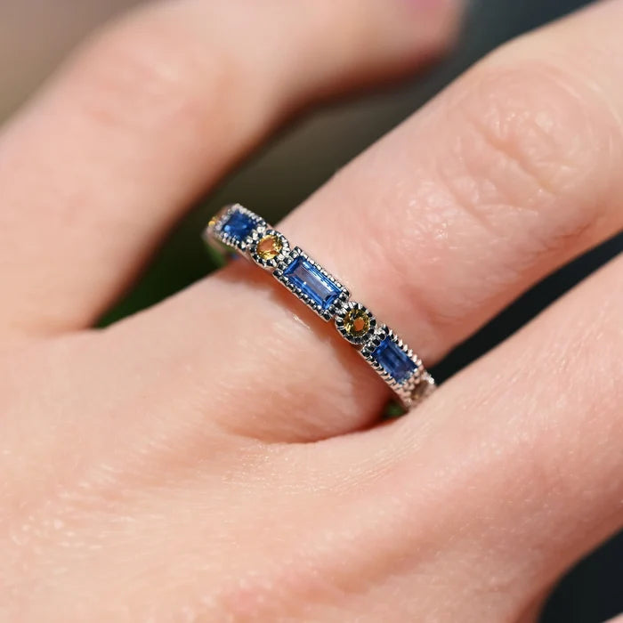 Ari Art Deco Blue Topaz & Citrine Ring- Sterling Silver by Aquamarise, featuring emerald cut Swiss blue topaz and round citrine stones in a delicate sterling silver band.