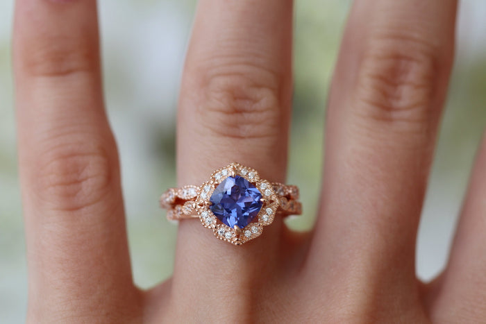 Tanzanite Ring- 14K Rose Gold Vermeil by Aquamarise featuring a violet-blue cushion-cut stone with vintage-inspired diamond accents on an elegant rose gold band.