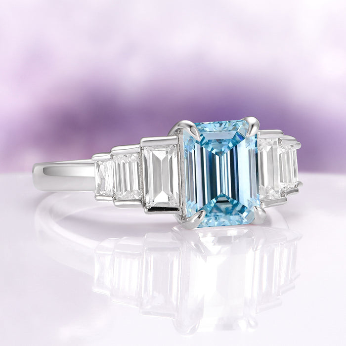 Art Deco Emerald Cut Aquamarine Engagement Ring in Sterling Silver by Aquamarise, featuring a stunning emerald-cut aquamarine center stone flanked by tapered baguette clear gemstones on a polished sterling silver band, part of Sterling Silver Rings, March Birthstone Jewelry, Engagement Rings for Women, and Meaningful Jewelry Gifts collections.