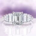 Art Deco Emerald Cut White Sapphire Engagement Ring in Sterling Silver by Aquamarise featuring a radiant emerald-cut white sapphire center stone with tapered baguette accents on a polished sterling silver band, part of Sterling Silver Rings, September Birthstone Jewelry, Engagement Rings for Women, and New Arrivals collections.