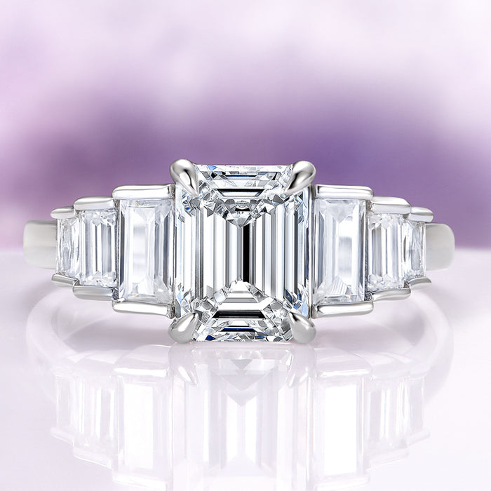 Art Deco Emerald Cut White Sapphire Engagement Ring in Sterling Silver by Aquamarise featuring a radiant emerald-cut white sapphire center stone with tapered baguette accents on a polished sterling silver band, part of Sterling Silver Rings, September Birthstone Jewelry, Engagement Rings for Women, and New Arrivals collections.