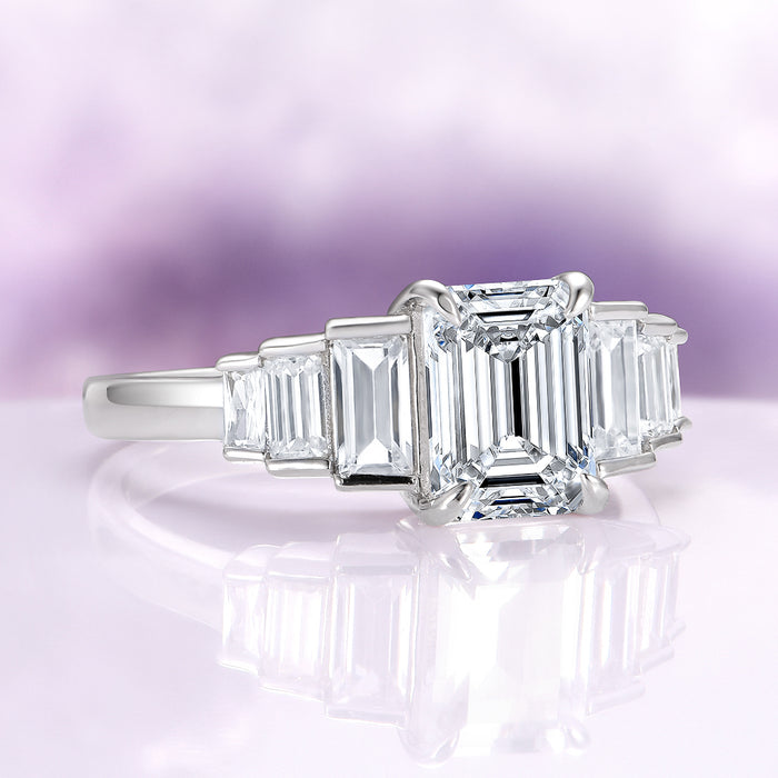 Art Deco Emerald Cut White Sapphire Engagement Ring in Sterling Silver by Aquamarise, showcasing a radiant emerald-cut white sapphire center stone accented by tapered baguette white sapphires on a polished sterling silver band, ideal for Sterling Silver Rings, September Birthstone Jewelry, Engagement Rings for Women, and Meaningful Jewelry Gifts collections.