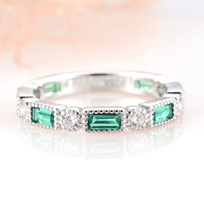 Ari Art Deco Emerald Wedding Band- Sterling Silver by Aquamarise, featuring alternating rectangular emerald and round simulated diamond stones with milgrain edges on a polished silver band.