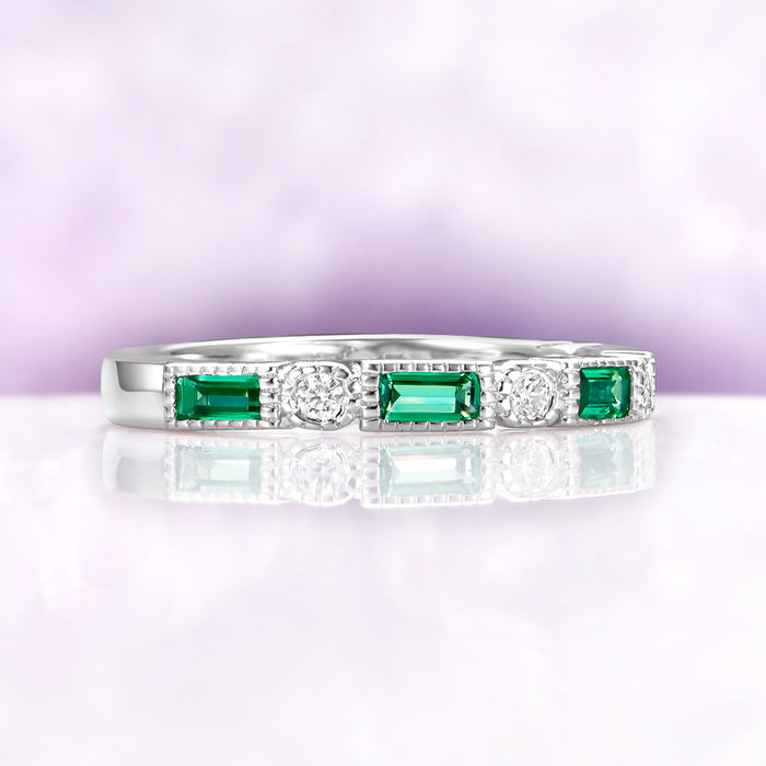 Art Deco Emerald Milgrain Wedding Band in Sterling Silver by Aquamarise featuring emerald-cut emeralds and round diamonds with detailed milgrain edges on a polished silver band.