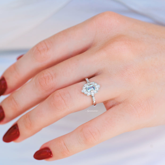 Art Deco Mosaic Aquamarine Engagement Ring in 14K White Gold by Aquamarise Gold, showcasing an emerald-cut ice blue aquamarine center with geometric diamond accents on a polished white gold band, part of Solid Gold Engagement Rings and March Birthstone Jewelry collections.
