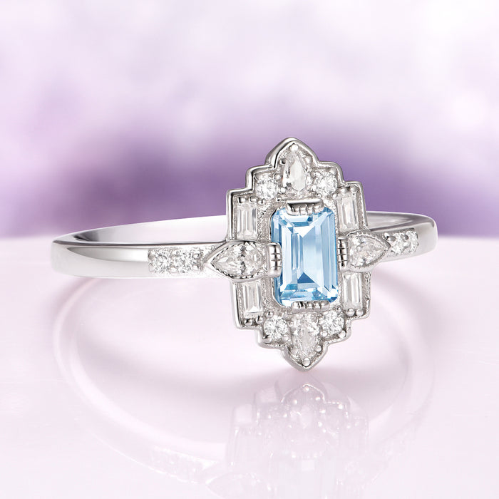 Art Deco Mosaic Aquamarine Engagement Ring in 14K White Gold featuring a radiant emerald-cut ice blue aquamarine centerpiece accented by pear-shaped and round diamonds on a slender polished band by Aquamarise Gold, highlighted in Solid Gold Engagement Rings and March Birthstone Jewelry collections.