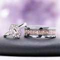 Art Deco morganite engagement ring with marquise and baguette accents beside a faceted men's band with a crushed morganite inlay
