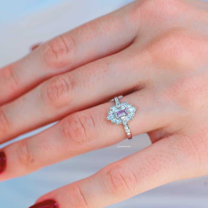 Art Deco Mosaic Morganite Couples Ring Set by Aquamarise featuring a rectangular pink morganite center stone with diamond accents on a sterling silver band, styled on a hand with red nail polish.