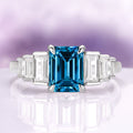 Art Deco Natural London Blue Topaz Engagement Ring in Sterling Silver by Aquamarise, featuring an emerald-cut deep blue topaz center stone flanked by tapered baguette clear gemstones on a polished sterling silver band, perfect for Sterling Silver Rings, November Birthstone, Engagement Rings for Women, and Birthstone Jewelry collections.