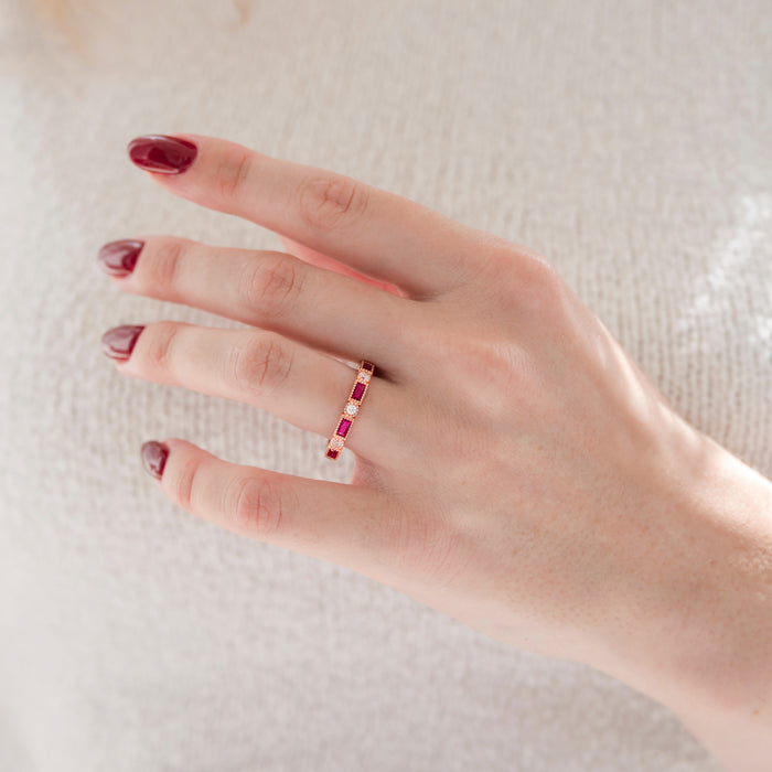 Art Deco Ruby Wedding Band in 14K Solid Rose Gold by Aquamarise Gold, featuring alternating emerald-cut rubies and round diamonds on a slender vintage-inspired band.