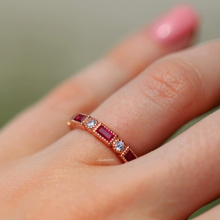 Art Deco Ruby Wedding Band in 14K Solid Rose Gold by Aquamarise Gold, featuring alternating emerald-cut lab-grown rubies and round diamonds on a vintage-inspired rose gold band.
