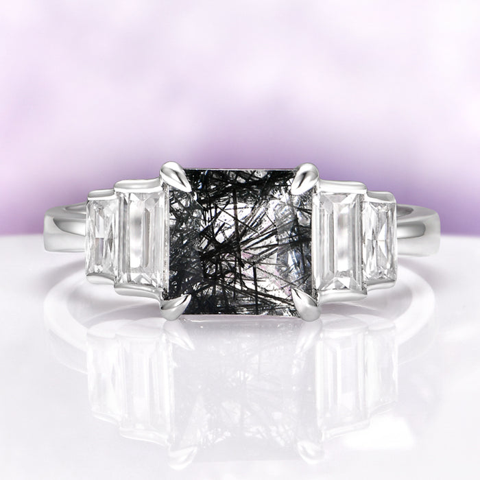 Art Deco Rutilated Quartz Engagement Ring in Sterling Silver by Aquamarise, featuring a square rutilated quartz center flanked by tapered baguette clear gemstones on a polished silver band.