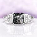 Art Deco Rutilated Quartz Engagement Ring in Sterling Silver by Aquamarise, featuring a square rutilated quartz center flanked by tapered baguette clear gemstones on a polished silver band.