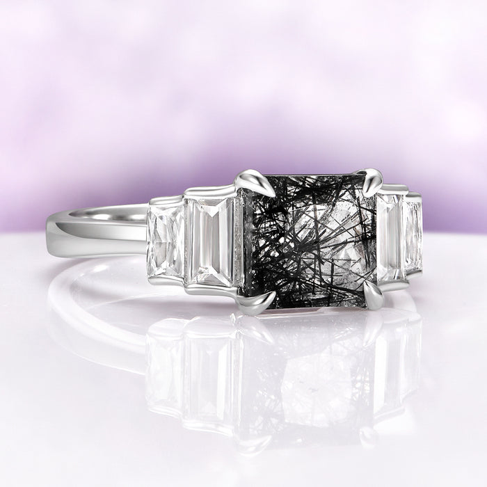 Art Deco Rutilated Quartz Engagement Ring in Sterling Silver by Aquamarise, featuring a square rutilated quartz center flanked by tapered baguette white gemstones on a polished silver band.