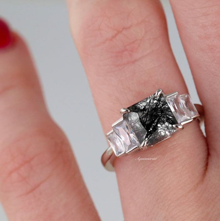 Art Deco Rutilated Quartz Engagement Ring in Sterling Silver by Aquamarise, featuring a square rutilated quartz flanked by clear tapered gemstones on a polished silver band.