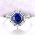 Asscher Cut Art Deco Bezel Set Blue Sapphire Ring in Sterling Silver by Aquamarise, featuring a deep blue sapphire surrounded by a diamond halo on a sleek silver band.