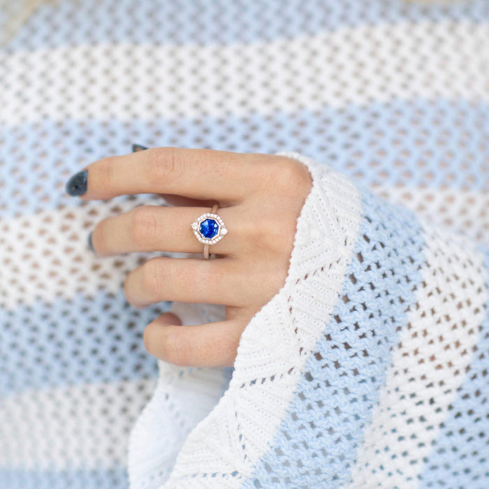 Asscher Cut Art Deco Bezel Set Blue Sapphire Ring in Sterling Silver by Aquamarise, showcasing a radiant blue sapphire framed by a geometric diamond halo on a sleek silver band.