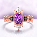 Aurelia Amethyst & Black Onyx Leaf Engagement Ring in 14K Solid Rose Gold by Aquamarise Gold, featuring an oval amethyst center with black onyx accents and delicate leaf-inspired band design.