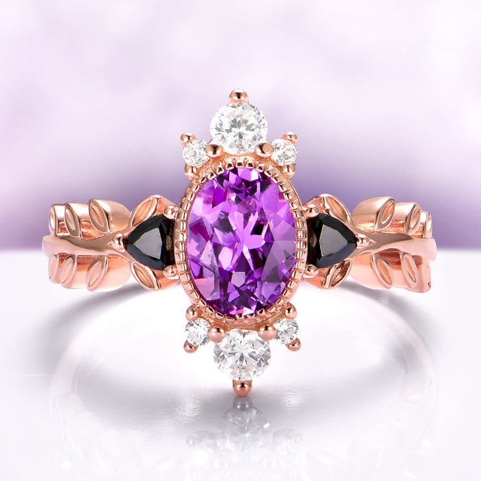 Aurelia Amethyst & Black Onyx Leaf Engagement Ring in 14K Solid Rose Gold by Aquamarise Gold, featuring an oval amethyst center with black onyx accents and delicate leaf-inspired band design.