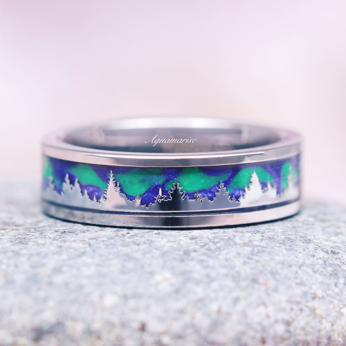 Aurora Borealis Forest Couples Ring Set- Northern Lights & Trees featuring a detailed silhouette of a forest with shimmering green and blue northern lights inlay on a polished silver band by Aquamarise, inspired by celestial and nature themes.