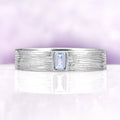Celtic Aquamarine Couples Ring Set by Aquamarise featuring a textured sterling silver band with a rectangular aquamarine center stone, ideal for matching couples rings and meaningful gifts.