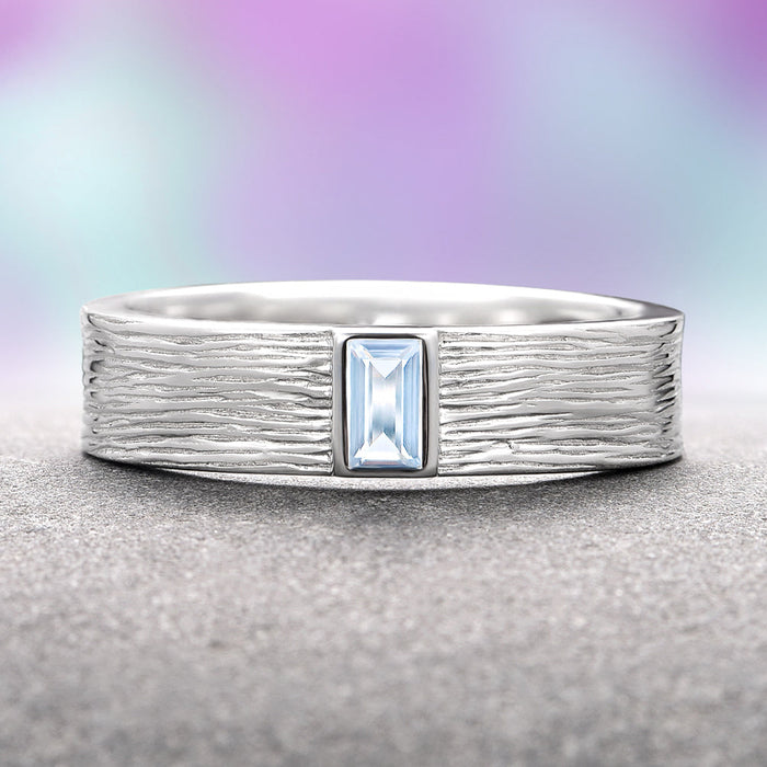 Rustic Aquamarine Wedding Band- 14K White Gold by Aquamarise Gold, featuring an emerald-cut aquamarine set in a textured white gold band, part of Solid Gold Engagement Rings, March Birthstone Jewelry, and Nature Inspired Men’s Bands collections.
