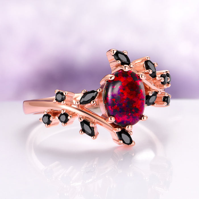 Black Fire Opal & Onyx Leaf Ring in 14K Rose Gold Vermeil showcasing a vivid oval black fire opal surrounded by marquise and round black onyx stones set on rose gold vermeil branches, crafted by Aquamarise from the Rose Gold Vermeil Rings and October Birthstone collections.