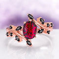 Black Fire Opal & Onyx Leaf Ring in 14K Rose Gold Vermeil features an oval black fire opal center stone with deep red flashes set in a rose gold vermeil band, accented with marquise and round black onyx stones.